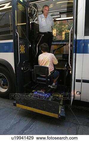 Boy with Muscular Dystrophy, utilizing a scooter/cart for mobility, getting on a city bus via a chair lift. View Large Photo Image Stock Photo - Boy with Muscular Dystrophy, utilizing a scooter/cart for mobility, getting on a city bus via a chair lift.. Fotosearch