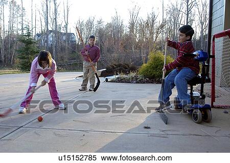 Children with disabilities playing street hockey. View Large Photo Image Stock Photography - Children with disabilities playing street hockey.. Fotosearch