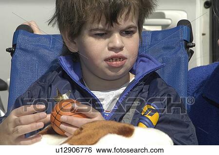 Close shot of a boy (autistic) in a wheelchair with a ball in his hand View Large Photo Image Stock Photograph - Close shot of a boy (autistic) in a wheelchair with a ball in his hand. Fotosearch