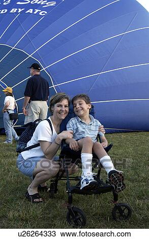 Excited little boy with a disability hoping to have a ride in an ôaccessibleö hot air balloon. View Large Photo Image Stock Image - Excited little boy with a disability hoping to have a ride in an ôaccessibleö hot air balloon.. Fotosearch