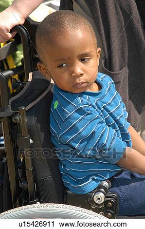 Little boy with a disability not so sure about what is happening. View Large Photo Image Stock Image - Little boy with a disability not so sure about what is happening.. Fotosearch