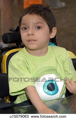 Stock Image - Little boy with disabilities attending a family outing.. Fotosearch