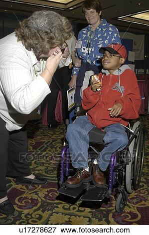 Little boy with multiple disabilities posing for the camera. View Large Photo Image Stock Photo - Little boy with multiple disabilities posing for the camera.. Fotosearch