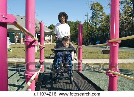 Little boy with multiple disabilities, utilizing a wheelchair for mobility, heading for the accessible playground to play with his friends. View Large Photo Image Stock Photograph - Little boy with multiple disabilities, utilizing a wheelchair for mobility, heading for the accessible playground to play with his friends.. Fotosearch