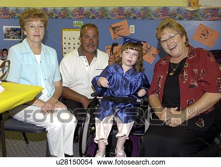 Little girl with multiple disabilities sharing the excitement of her pre-school graduation with her dad and grandmothers. View Large Photo Image Picture - Little girl with multiple disabilities sharing the excitement of her pre-school graduation with her dad and grandmothers.. Fotosearch