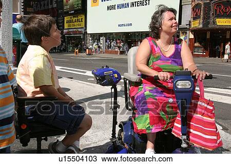 Mother and son sightseeing in New York using scooters for mobility. View Large Photo Image Stock Image - Mother and son sightseeing in New York using scooters for mobility.. Fotosearch