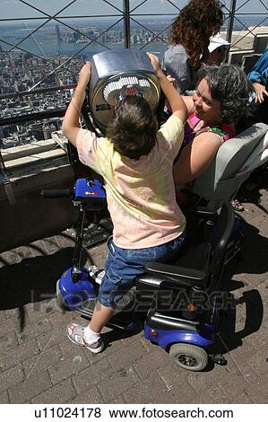 Stock Photo - Mother and son with disabilities sightseeing while on vacation.. Fotosearch