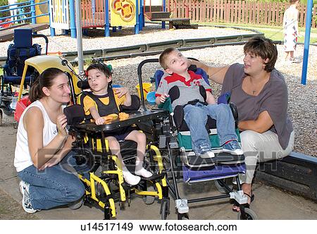 Two boys with multiple disabilities on the playground with their care providers. View Large Photo Image Stock Photo - Two boys with multiple disabilities on the playground with their care providers.. Fotosearch