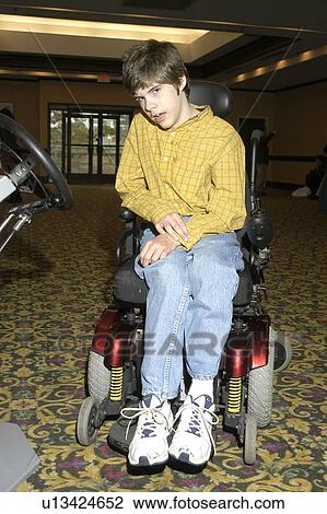 Young man with significant disabilities utilizing a motorized chair for mobility. View Large Photo Image Stock Image - Young man with significant disabilities utilizing a motorized chair for mobility.. Fotosearch