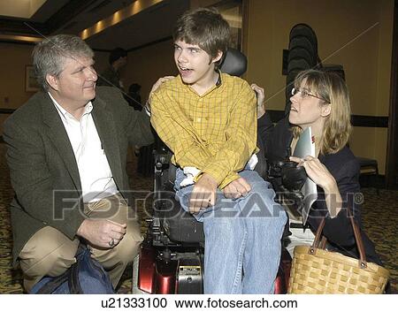 Young man with significant disabilities spending time with family and friends. View Large Photo Image Stock Image - Young man with significant disabilities spending time with family and friends.. Fotosearch