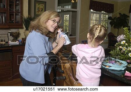 A grandmother plays with dolls with her grand daughter. View Large Photo Image Stock Image - A grandmother plays with dolls with her grand daughter.. Fotosearch