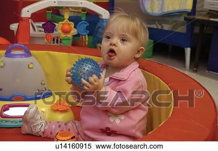 Absolutely adorable image of a little girl with Down's Syndrome playing at school. View Large Photo Image Stock Photography - Absolutely adorable image of a little girl with Down's Syndrome playing at school.. Fotosearch