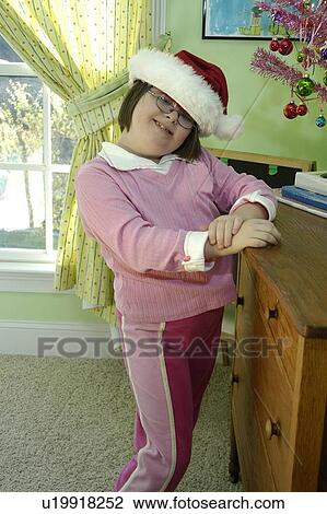 Adorable little girl with Down Syndrome getting in the holiday spirit. View Large Photo Image Stock Image - Adorable little girl with Down Syndrome getting in the holiday spirit.. Fotosearch