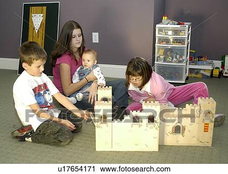 Children, including a child with Down Syndrome, playing with a castle. View Large Photo Image Stock Image - Children, including a child with Down Syndrome, playing with a castle.. Fotosearch