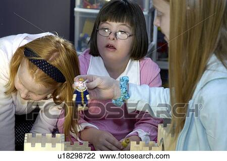 Children, including a child with Down Syndrome, playing with a castle. View Large Photo Image Stock Image - Children, including a child with Down Syndrome, playing with a castle.. Fotosearch