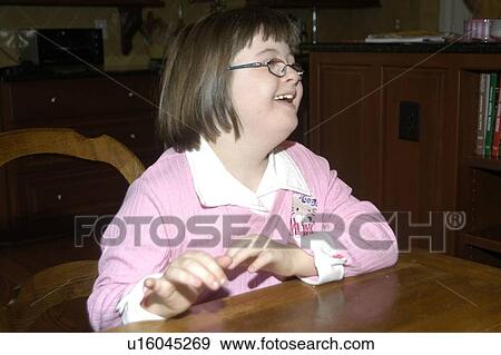 Girl with Down Syndrome clowning around and having fun. View Large Photo Image Stock Photo - Girl with Down Syndrome clowning around and having fun.. Fotosearch