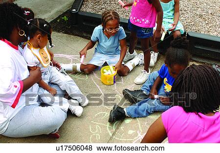 Group of children with disabilities having a great time with sidewalk art! View Large Photo Image Stock Photo - Group of children with disabilities having a great time with sidewalk art!. Fotosearch