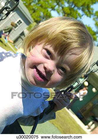 Little girl with Downs Syndrome playing on the swing. View Large Photo Image Stock Photography - Little girl with Downs Syndrome playing on the swing.. Fotosearch
