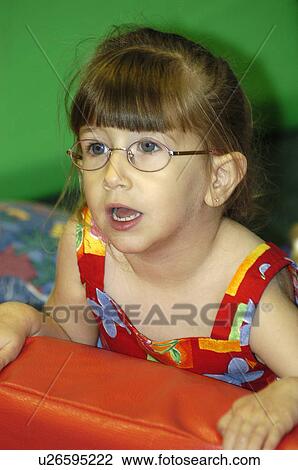 Precious little girl with disabilities, including a visual impairment, looking for reassurance from her instructor. View Large Photo Image Stock Image - Precious little girl with disabilities, including a visual impairment, looking for reassurance from her instructor.. Fotosearch