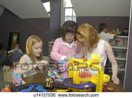 Several children, one with Down Syndrome, playing together with various toys and games. View Large Photo Image Stock Image - Several children, one with Down Syndrome, playing together with various toys and games.. Fotosearch