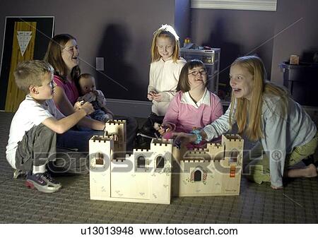 Several children, one with Down Syndrome, playing with toys. View Large Photo Image Stock Photo - Several children, one with Down Syndrome, playing with toys.. Fotosearch
