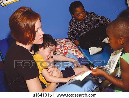 Teacher and children with and without disabilities at story time, reading and discussing books they are reading. View Large Photo Image Stock Image - Teacher and children with and without disabilities at story time, reading and discussing books they are reading.. Fotosearch