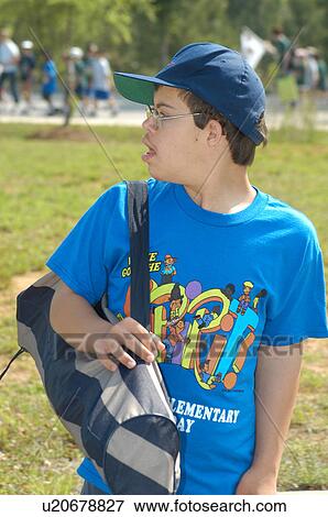 Teenage boy with DownÆs Syndrome heading off to play baseball with his friends. View Large Photo Image Stock Photo - Teenage boy with DownÆs Syndrome heading off to play baseball with his friends.. Fotosearch