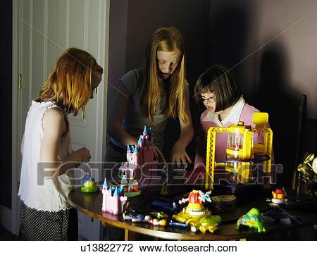 Three children, one with Down Syndrome, playing with toys. View Large Photo Image Stock Image - Three children, one with Down Syndrome, playing with toys.. Fotosearch