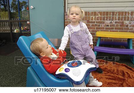 Two absolutely adorable children, one with disabilities, one without, playing together at school. View Large Photo Image Stock Photo - Two absolutely adorable children, one with disabilities, one without, playing together at school.. Fotosearch