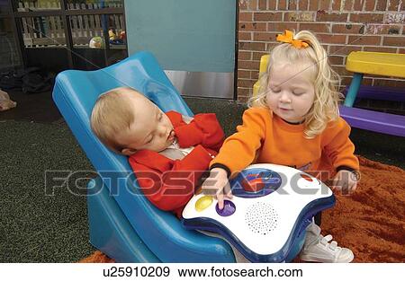 Two absolutely adorable children, one with disabilities, one without, playing together at school. View Large Photo Image Stock Photo - Two absolutely adorable children, one with disabilities, one without, playing together at school.. Fotosearch