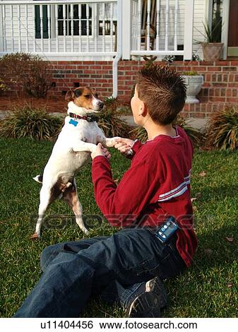 Stock Photograph - Young boy with diabetics, plays with his dog.. Fotosearch