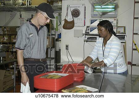 A man is learning new work skills with the assistance of a support person. View Large Photo Image Stock Photo - A man is learning new work skills with the assistance of a support person.. Fotosearch