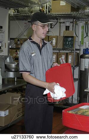 A man with a disability cleaning trays at a fast food restaurant. View Large Photo Image Stock Image - A man with a disability cleaning trays at a fast food restaurant.. Fotosearch
