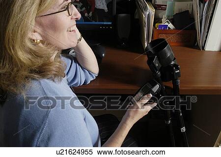 Stock Photography - Attractive female talks on the phone.. Fotosearch