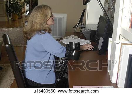 Female works on computer at home. View Large Photo Image Stock Image - Female works on computer at home.. Fotosearch