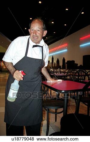 Man with a disability cleaning tables as he finishes his shift at a grocery store cafe. View Large Photo Image Stock Photo - Man with a disability cleaning tables as he finishes his shift at a grocery store cafe.. Fotosearch