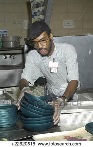 Man with disabilities in a commercial kitchen washing dishes. View Large Photo Image Stock Photo - Man with disabilities in a commercial kitchen washing dishes.. Fotosearch