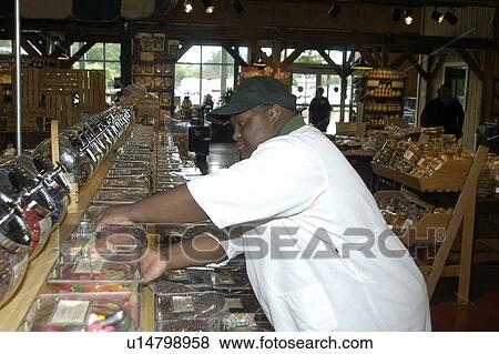 Man with disabilities working in a food store. View Large Photo Image Stock Photo - Man with disabilities working in a food store.. Fotosearch