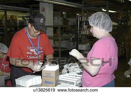Two people with disabilities working in a commercial kitchen. View Large Photo Image Stock Photo - Two people with disabilities working in a commercial kitchen.. Fotosearch