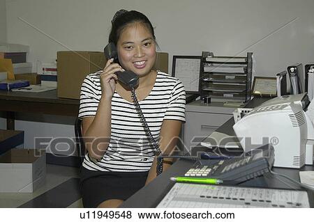 Woman with a disability answering the telephone. View Large Photo Image Stock Photo - Woman with a disability answering the telephone.. Fotosearch