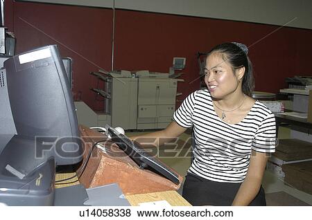 Woman with a disability in an office using a computer View Large Photo Image Stock Photo - Woman with a disability in an office using a computer. Fotosearch