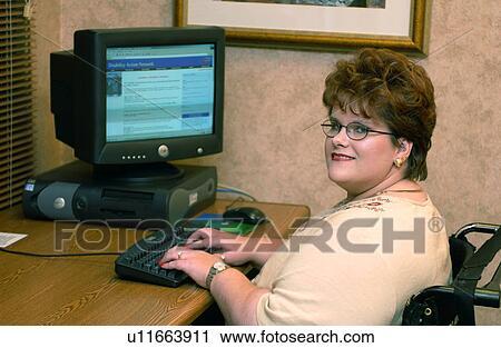 Woman with a disability utilizing a wheelchair for mobility working on her computer in her office. View Large Photo Image Stock Image - Woman with a disability utilizing a wheelchair for mobility working on her computer in her office.. Fotosearch