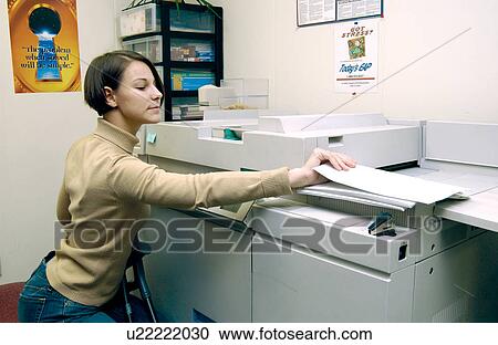 Woman with a disability, utilizing crutches to assist with mobility, making copies of documents as a part of her daily duties at work View Large Photo Image Stock Image - Woman with a disability, utilizing crutches to assist with mobility, making copies of documents as a part of her daily duties at work. Fotosearch