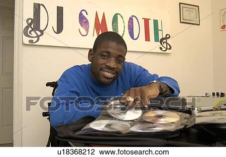 African-American man with multiple disabilities, preparing for his next gig - as a DJ for a local dance - a small business or micro-enterprise he started to produce income while living his dream of being a DJ. View Large Photo Image Stock Image - African-American man with multiple disabilities, preparing for his next gig - as a DJ for a local dance - a small business or micro-enterprise he started to produce income while living his dream of being a DJ.. Fotosearch