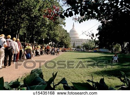 Stock Photo - Crowd of people with and without disabilities MARCHING to the CAPITOL as a part of the ADAPT MARCH ON WASHINGTON to advocate for the civil rights of people with disabilities.. Fotosearch
