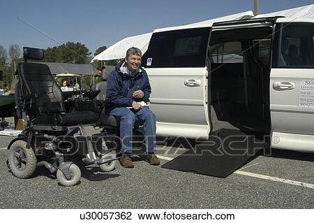 Man seated in a wheelchair beside a display wheelchair and van ramp View Large Photo Image Stock Image - Man seated in a wheelchair beside a display wheelchair and van ramp. Fotosearch