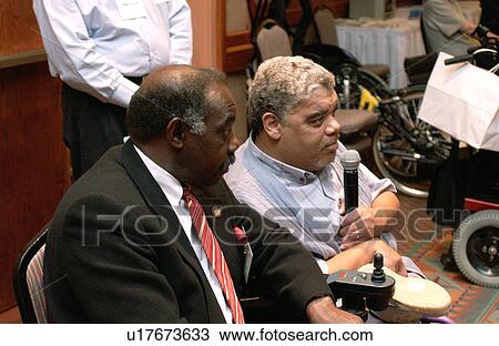Man with a disability asking a question of a presenter at a disability rights conference. View Large Photo Image Stock Image - Man with a disability asking a question of a presenter at a disability rights conference.. Fotosearch