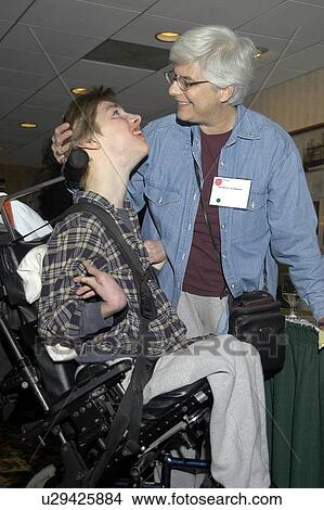 Picture - Mother and son sharing a loving exchange. The son has multiple disabilities.. Fotosearch