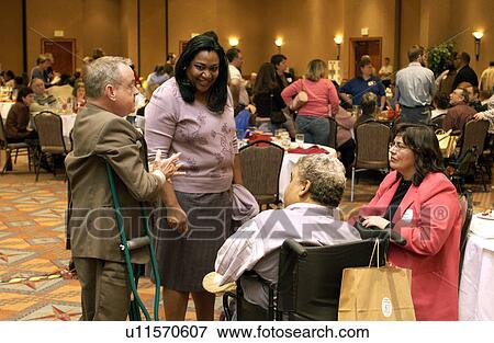 People with and without disabilities interacting and networking at the end of a conference. View Large Photo Image Stock Photo - People with and without disabilities interacting and networking at the end of a conference.. Fotosearch