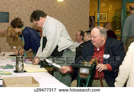People with disabilities gathering at the registration desk for a Disability Activist Conference/Meeting. View Large Photo Image Stock Photo - People with disabilities gathering at the registration desk for a Disability Activist Conference/Meeting.. Fotosearch